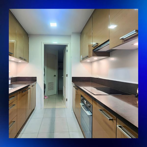 Modern kitchen with brown cabinets and tiled floor.