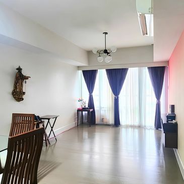 Bright room with blue curtains and wooden furniture.