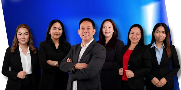 A professional group of six people posing confidently in business attire.