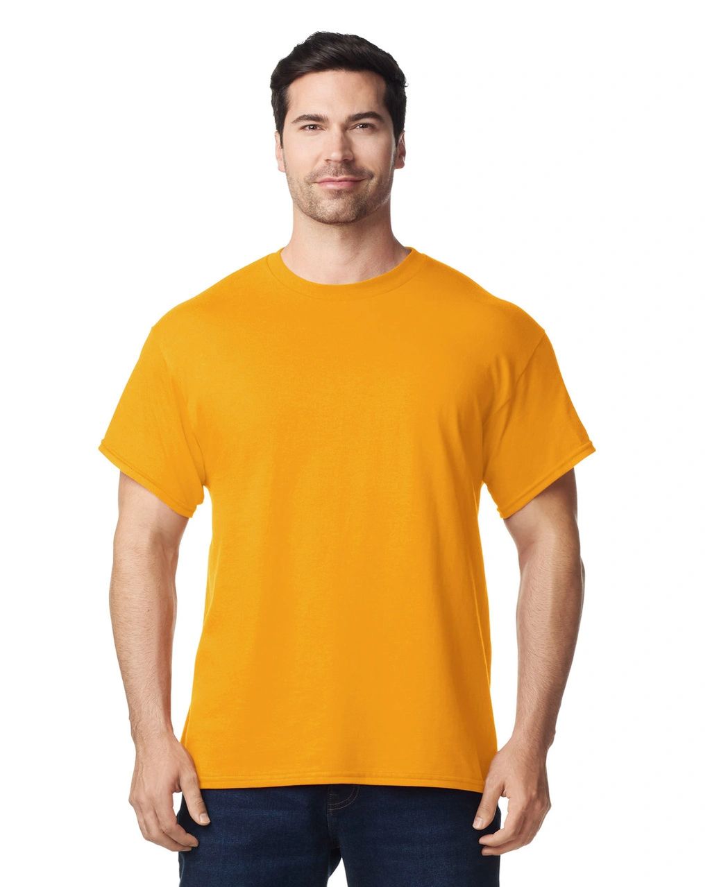 Man wearing a plain orange t-shirt and dark jeans, standing confidently.