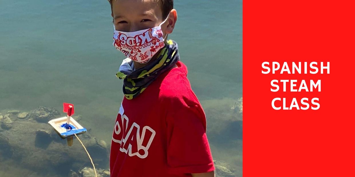 Young boy with mask and red shirt near water with a small boat.