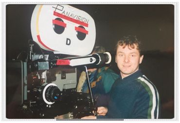 Man operating an old Panavision film camera.