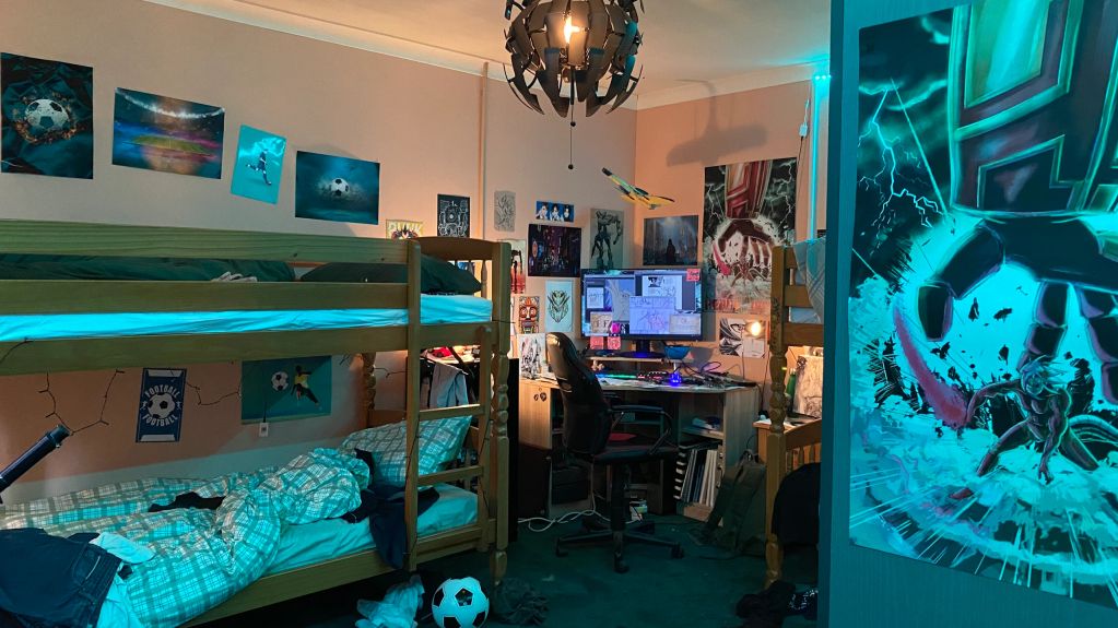 A cozy bedroom with bunk beds and a computer setup.