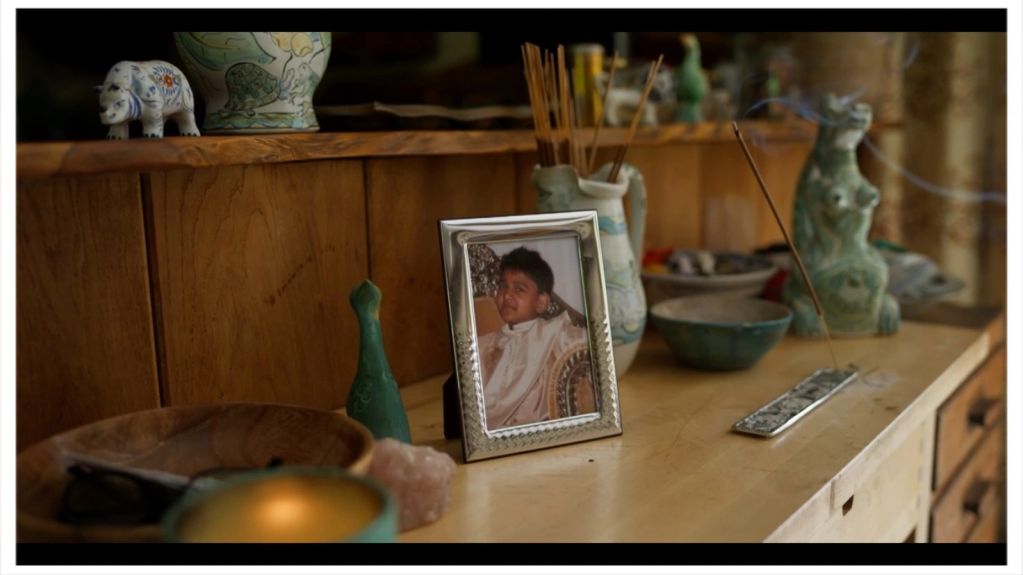 Photo frame and decorative items on a wooden surface.
