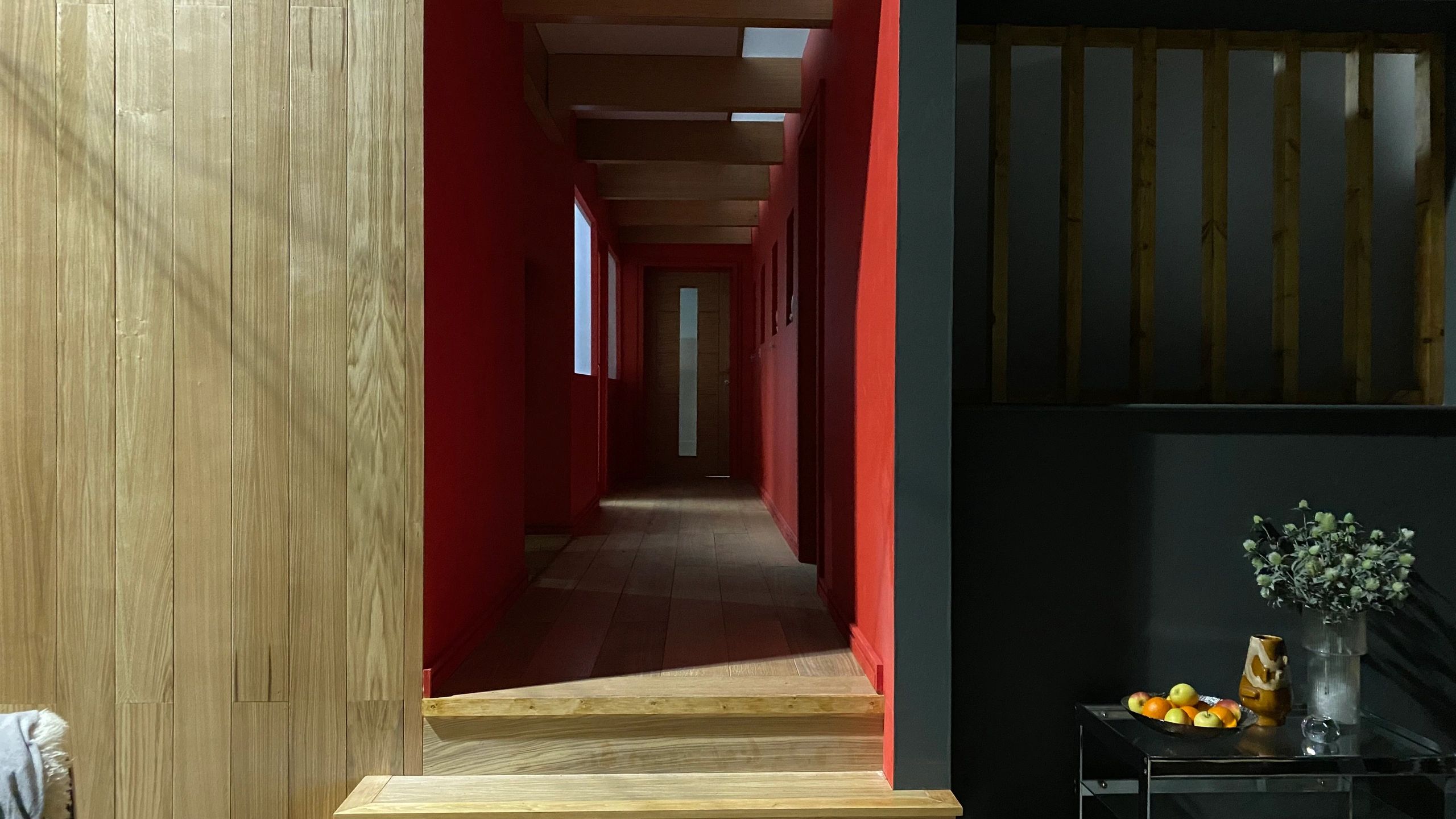 Interior hallway with red walls and wooden accents.