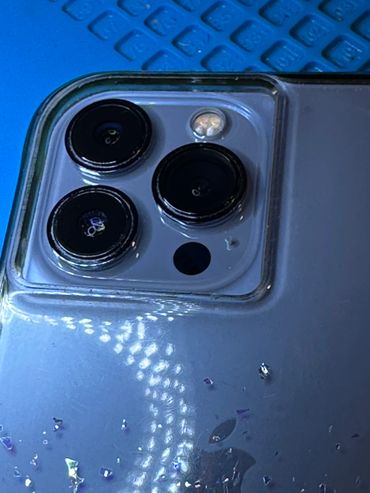 Close-up of a smartphone camera module with three lenses and a flash.