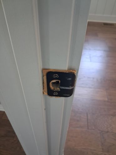 Cardboard shim used behind an door strike plate found during a Winchester, TN home inspection.