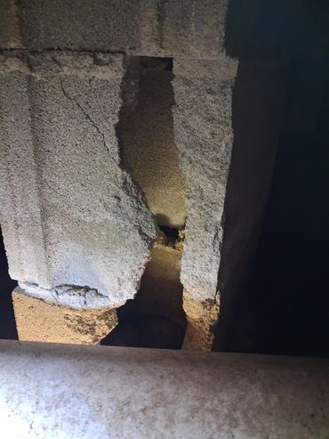 Broken concrete foundation block in a crawlspace found during an Athens, AL home inspection.