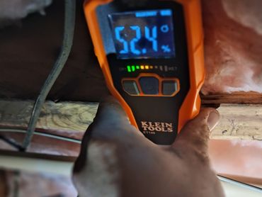 Klein ET140 moisture meter displaying a high reading on wood framing during an Athens, AL home inspe