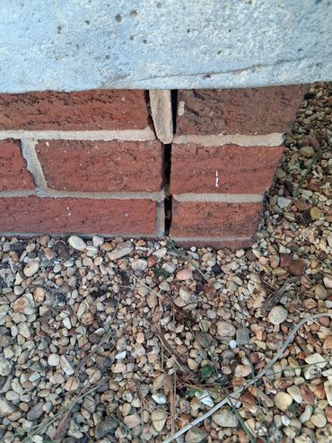 Vertical expansion gap in brick foundation veneer observed during an Athens, AL home inspection.