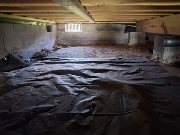 Improperly installed and incomplete moisture barrier in a Tullahoma, TN crawlspace.