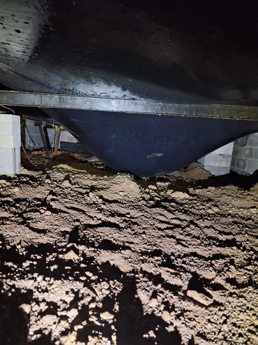 Belly board holding trapped water under a manufactured home in Estill Springs, TN home inspection.