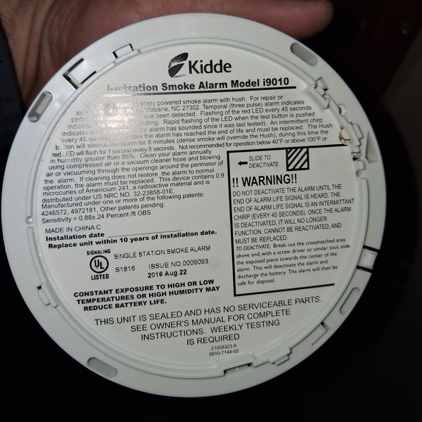 Close-up of a Kidde smoke alarm showing the manufacture date during a home inspection.

