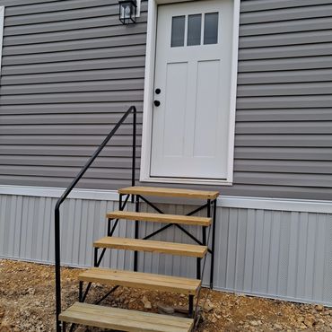 Unsecured exterior stairs with no landing and an unstable base in Leoma, TN.