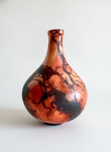 Decorative vase with black and reddish-brown abstract patterns.