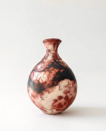 Decorative ceramic vase with marbled pattern.