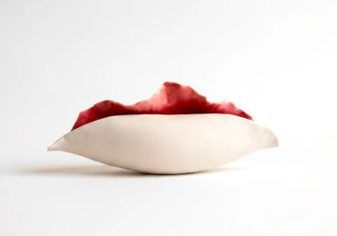 Abstract ceramic sculpture with red and white colors.