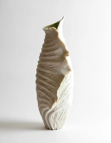 Unique sculptural ceramic vase with textured and flowing design.