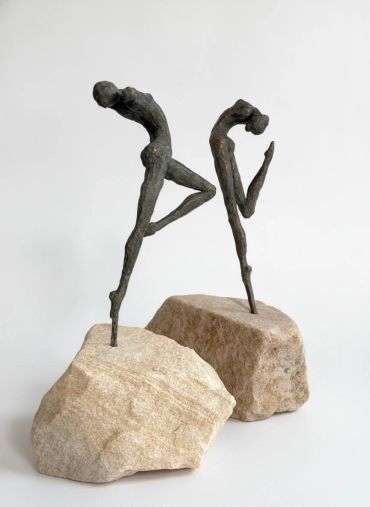 Abstract metal sculptures on rocks.