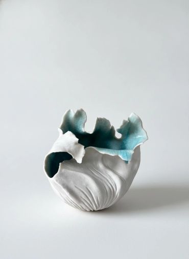 Artistic ceramic vase with blue and white glaze.