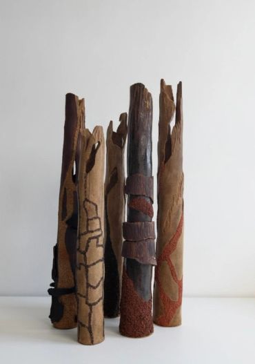 Abstract wooden sculptures with textured patterns.