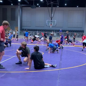 Two wrestling mats at the wrestling club, large facility with spectator seating