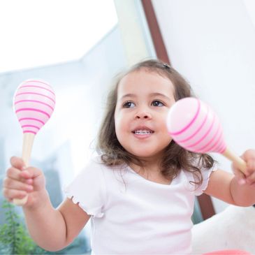 young girl playing maracas