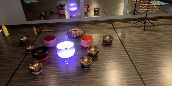 Meditation setup with singing bowls and glowing light.