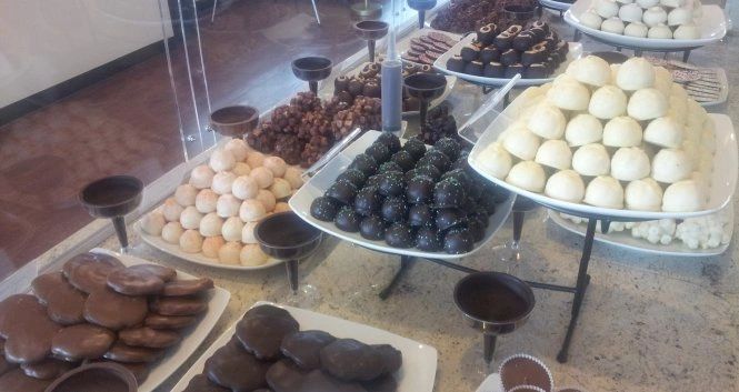 A display of various chocolate and cream-colored sweets.