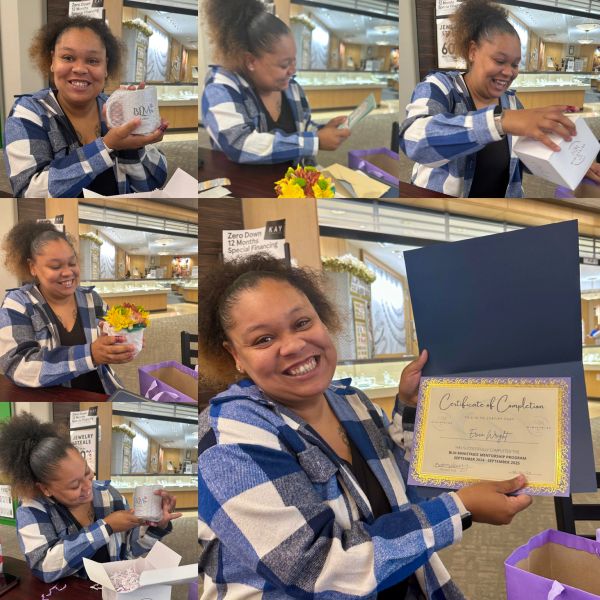 Woman joyfully opens gifts and holds a certificate of completion.