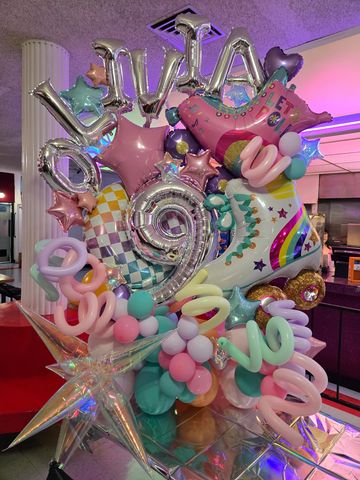 Colorful balloon arrangement with roller skate and number 9.