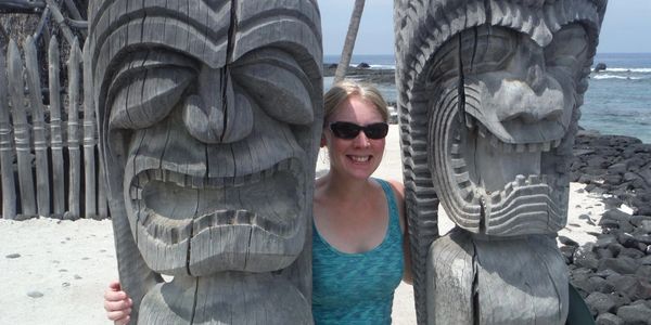 A woman take a picture with two stone