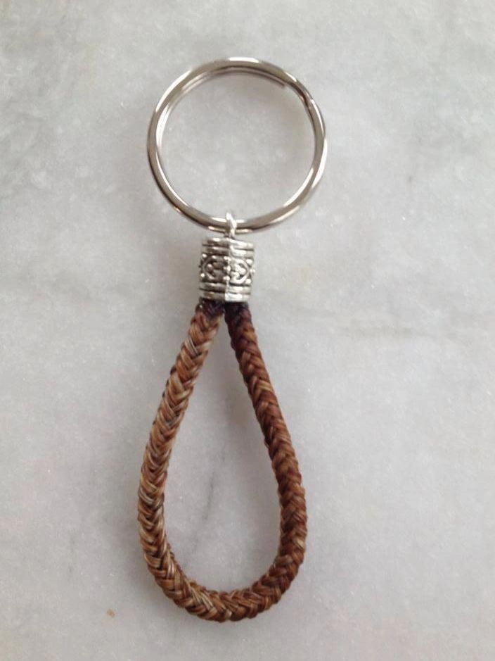 Keychain with braided leather loop and metal ring.