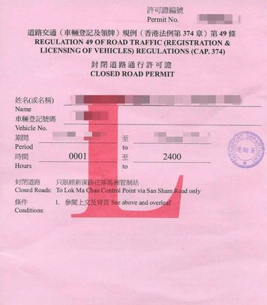 A pink closed road permit document with bilingual text and official stamps.