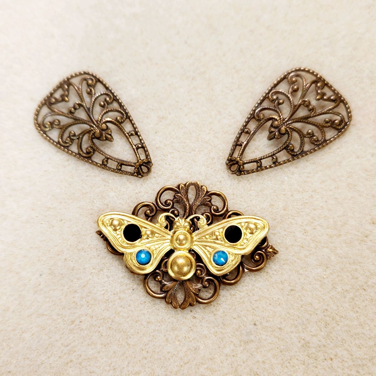 Artisan lace-inspired metal jewelry pieces.