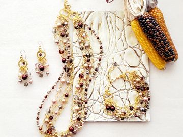 Beautiful shades of brown crystals and pearls connected with gold wire and gold chain.