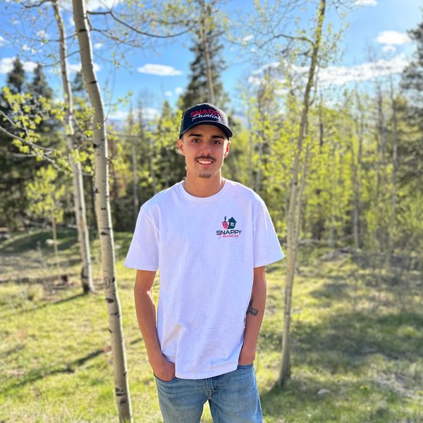 Young man in Snappy Painting attire outdoors.