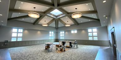 Spacious room with modern lighting and skylight.