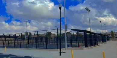 Empty tennis courts under a cloudy sky.