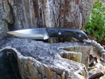 This knife is a great size for an every day user. The handle material is canvas micarta. Extremely d