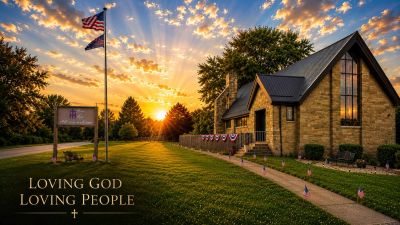 Sunset over a church with an American flag and a message of love for God and people.