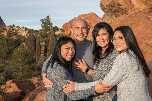 Family portrait of four at Garden of the Gods during sunset