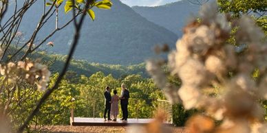 Couple exchanging vows in outdoor mountain setting.