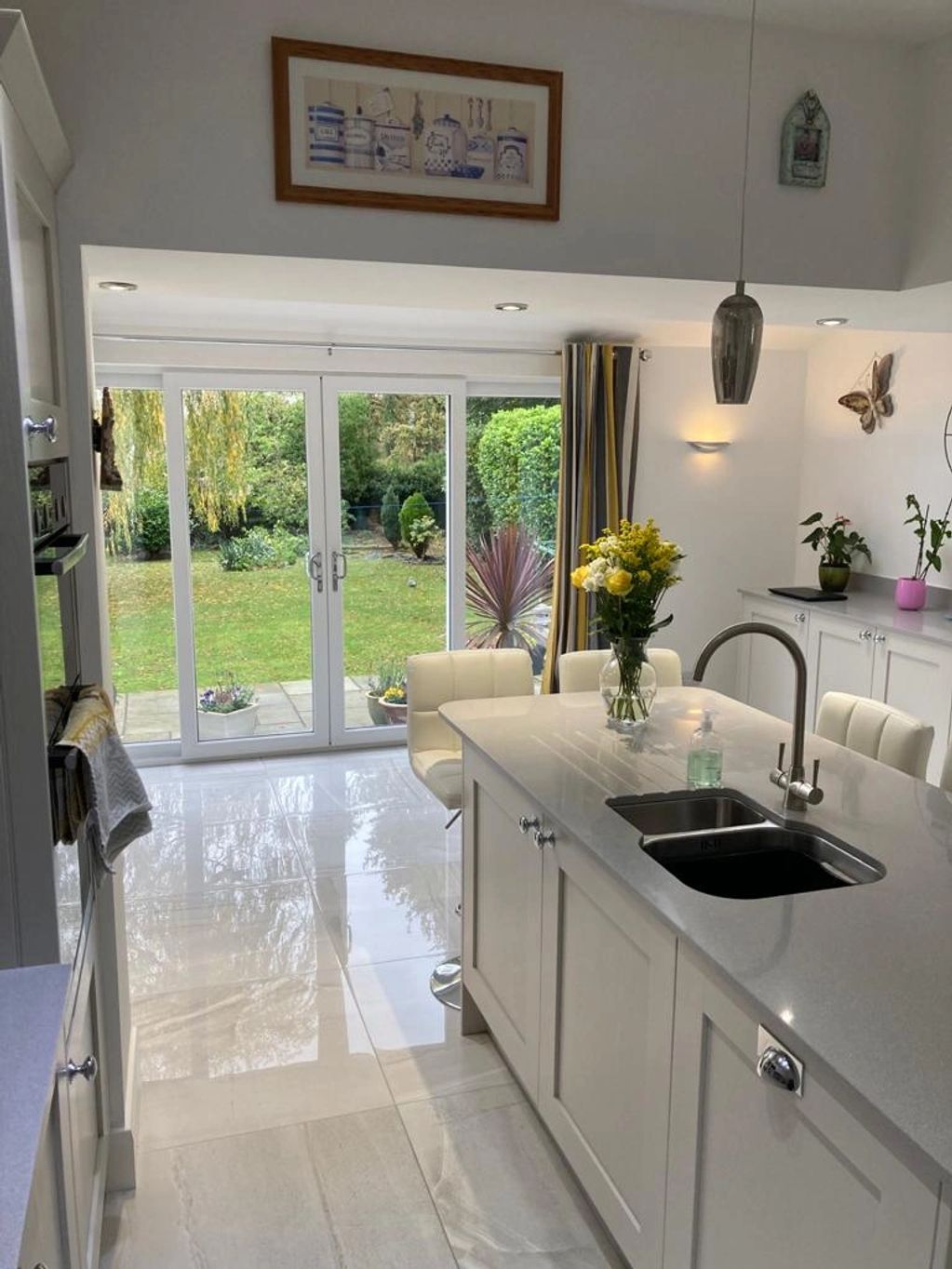 Kitchen floor tiled with Grey gloss porcelain tiles