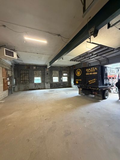Empty industrial garage with a delivery truck inside.