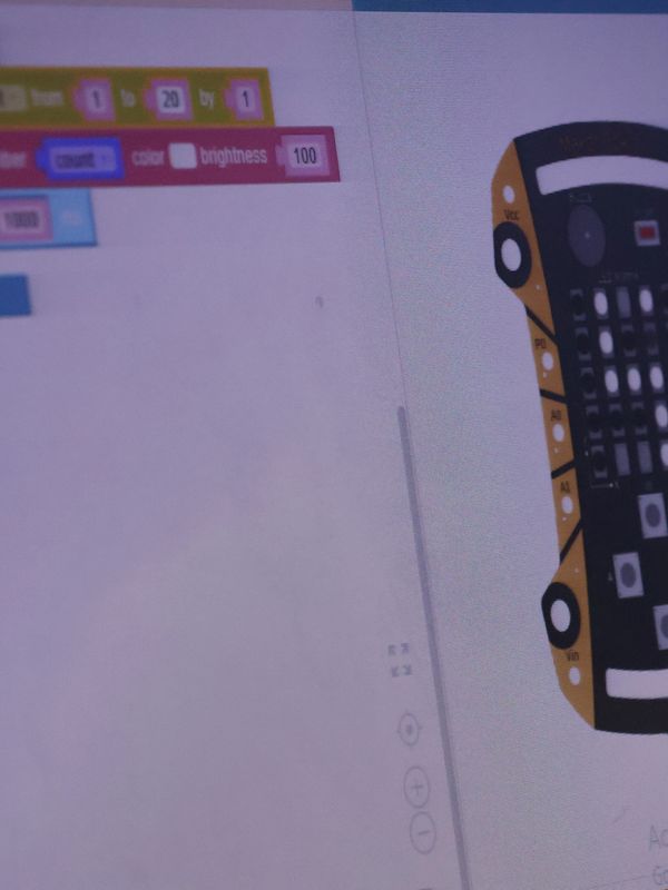 Coding interface with a microcontroller diagram on screen.