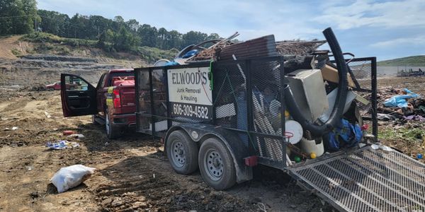Elwood's Junk Removal truck and trailer at the landfill/dump