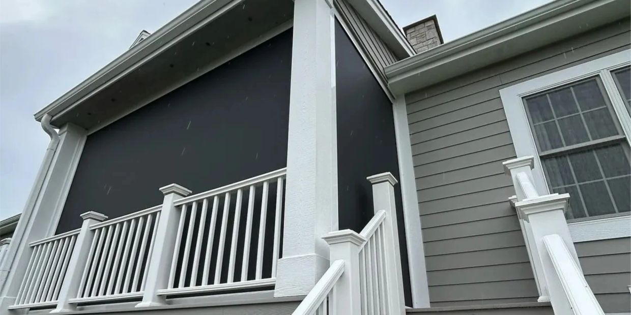 White railing and stairs leading to a porch with a black screen.