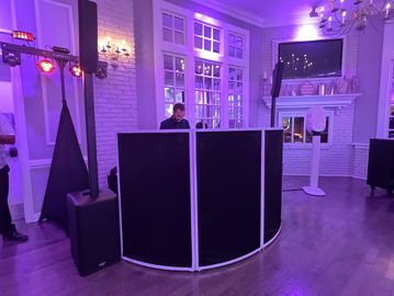DJ setup in a purple-lit room with a cozy ambiance.