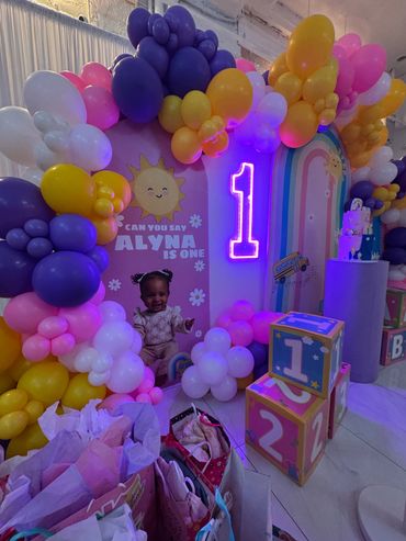 Colorful balloon arch and decorations for Alyna's first birthday party.